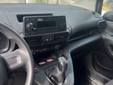 the interior of a car with a steering wheel and dashboard controls
