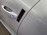 a close up of a car door handle with a sticker on it