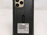 a close up of the back of a black phone case on a white surface