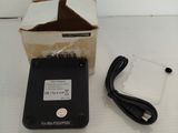 a box and a charger sitting on a table next to a box