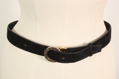 a black belt with a gold buckle on a mannequin