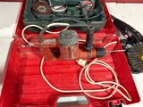 a red tool box with a drill and other tools in it