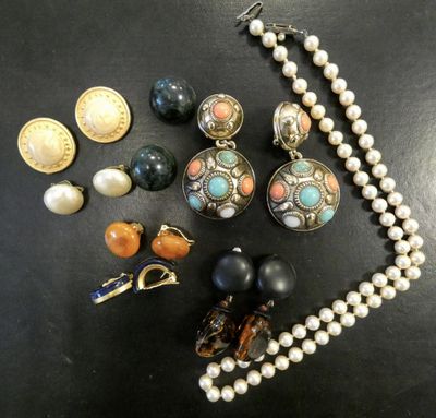 a close up of a necklace and earrings on a table