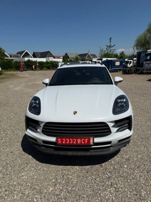the white porsche cayen is parked in the parking lot