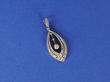 a silver pendant with a diamond on it on a blue surface