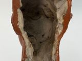 a bird that is sitting on top of a piece of clay