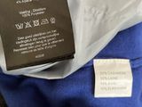 the label on the back of a blue shirt shows the size of the shirt