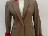 beige and red jacket on a mannequin stand on a white background