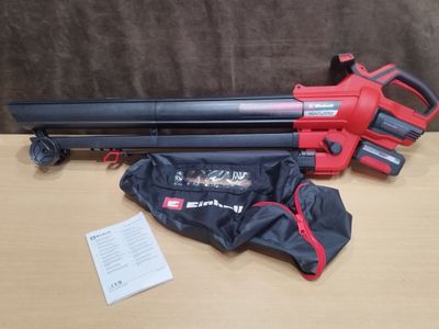 a red and black blower sitting on top of a table next to a bag