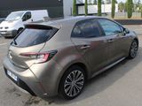 a silver car parked in a parking lot with other cars