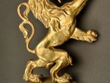 a gold statue of a lion on top of a pedestal