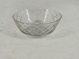 a clear glass bowl sitting on top of a white table