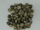 a pile of old brass buttons on a white surface