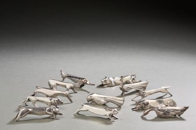 a lot of silver animal figurines sitting on a table