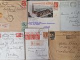 several old envelopes are stacked on top of each other on a table