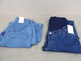 two pairs of blue jeans sitting on top of a table