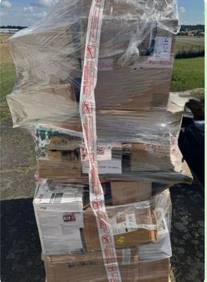 a large stack of boxes sitting on top of a pallet
