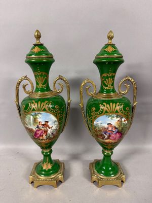 pair of green and gold vases with pictures of people on them