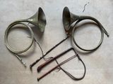 two horns, a horn, and a pair of scissors on a table