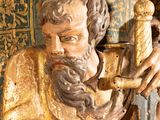 a statue of a man holding a bird in his hand