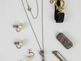 a group of jewelry including a necklace, bracelet, and ring