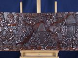 a wooden easel with a carving of a man and a woman on it