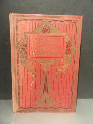 a red book with gold lettering on it sitting on a table