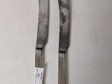 two knives that are sitting on a table