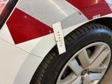 a red and white stripe on the side of a car