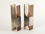 pair of modern metal bookends on a white background
