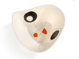 a white bowl with a black and orange face on it