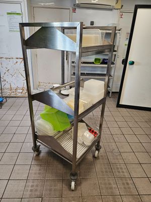 a metal cart that has some food on top of it