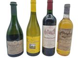 several bottles of wine are lined up on a white surface