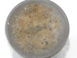a metal container that has a brown substance on it