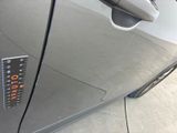 a close up of a car ' s door handle with a sticker on it