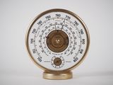 a gold and white clock that is on a stand