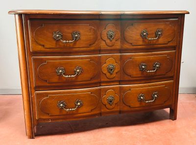 a wooden dresser with many drawers on top of it