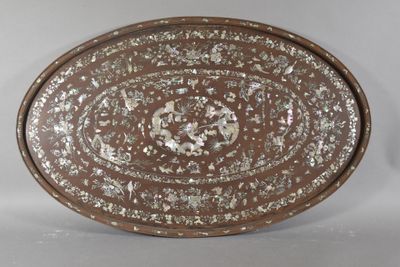 a brown plate with silver designs on it
