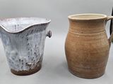 two vases sitting next to each other on a table