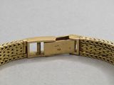 a close up of a gold bracelet with a clasp