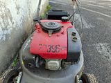 a lawn mower that is parked on the side of the road