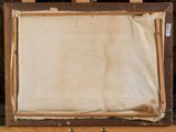 painting on easel with old paper and wooden frame on easel