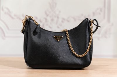 a black purse sitting on top of a wooden table