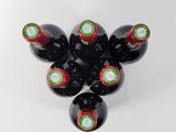 several bottles of wine are arranged in a circle on a white surface