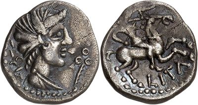 a close up of a coin with a horse and rider on it