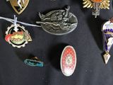 a lot of badges on a black cloth