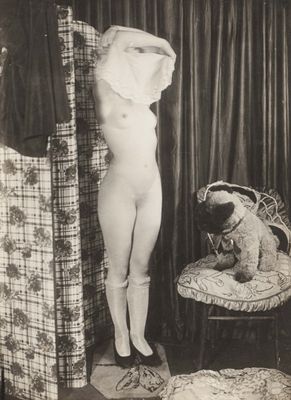 photographie en noir et blanc d'une femme nue debout à côté d'un ours en peluche