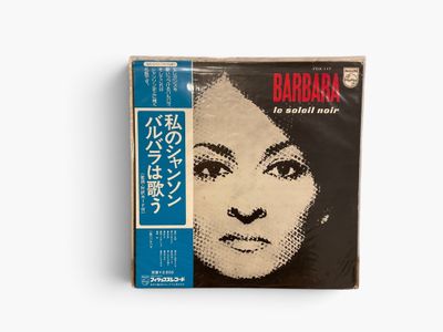 a close up of a book with a picture of a woman ' s face