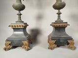 pair of antique bronze vases on pedestals on a white background