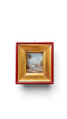 an old picture frame with a painting hanging on a wall